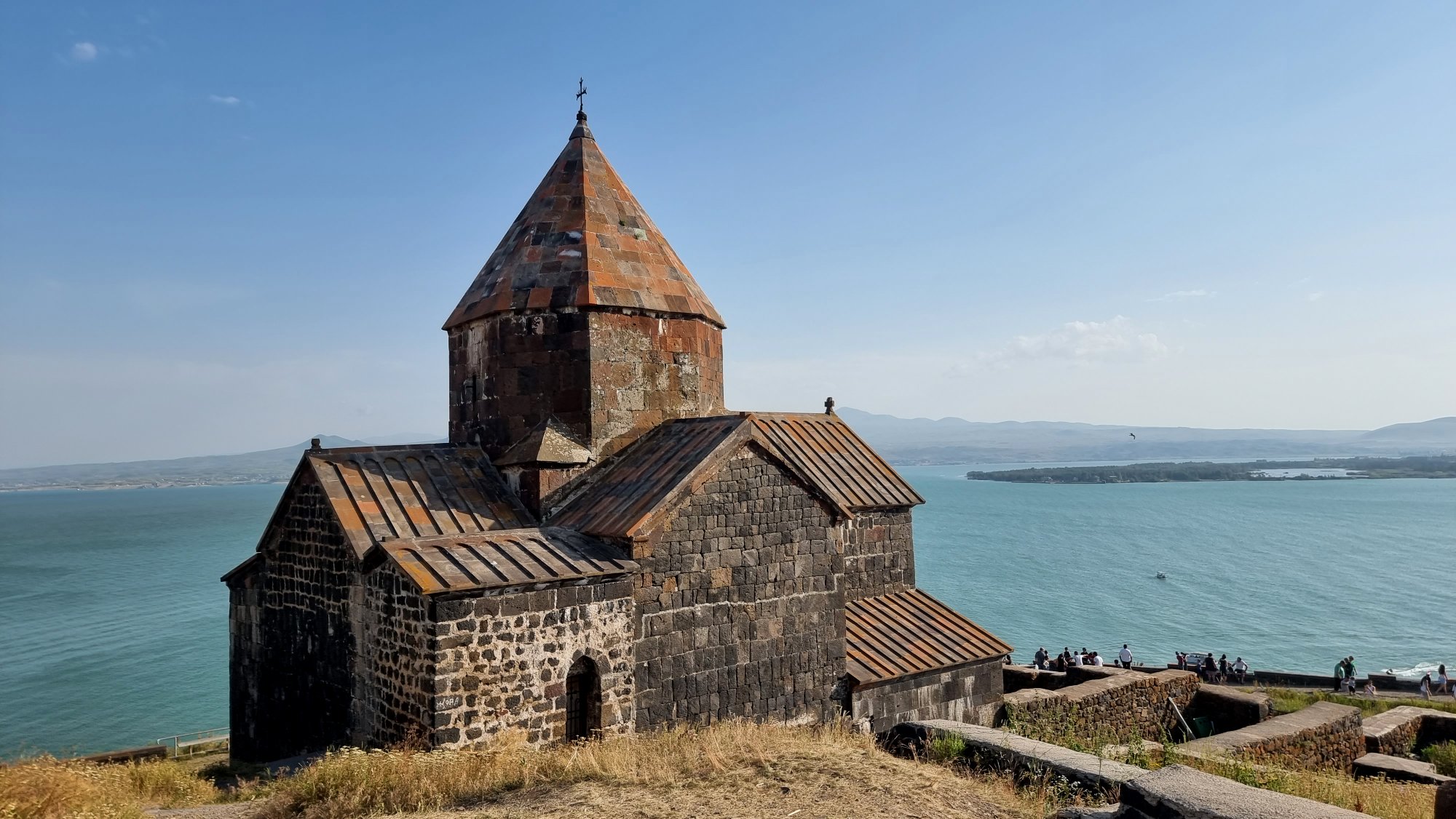 Das mittelalterliche Kloster Sevanavank aus dunklem Tuffstein auf einer Halbinsel über dem türkisfarbenen Sewansee in Armenien